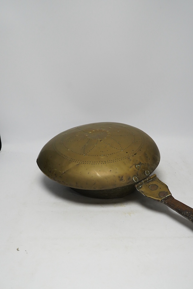 A 17th century brass and iron warming pan, 112cm. Condition - poor